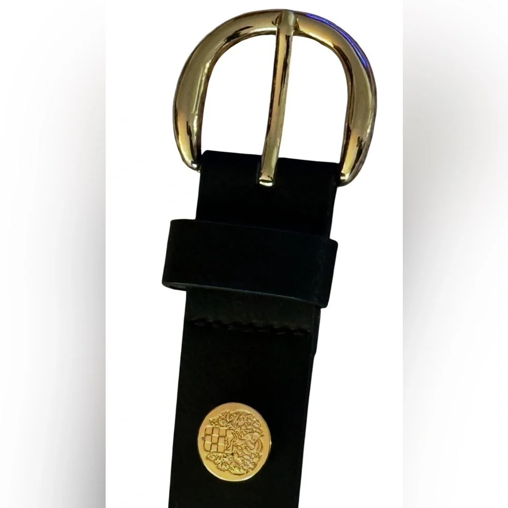 A Vince Camuto black belt with gold Buckle and emblem, size M.